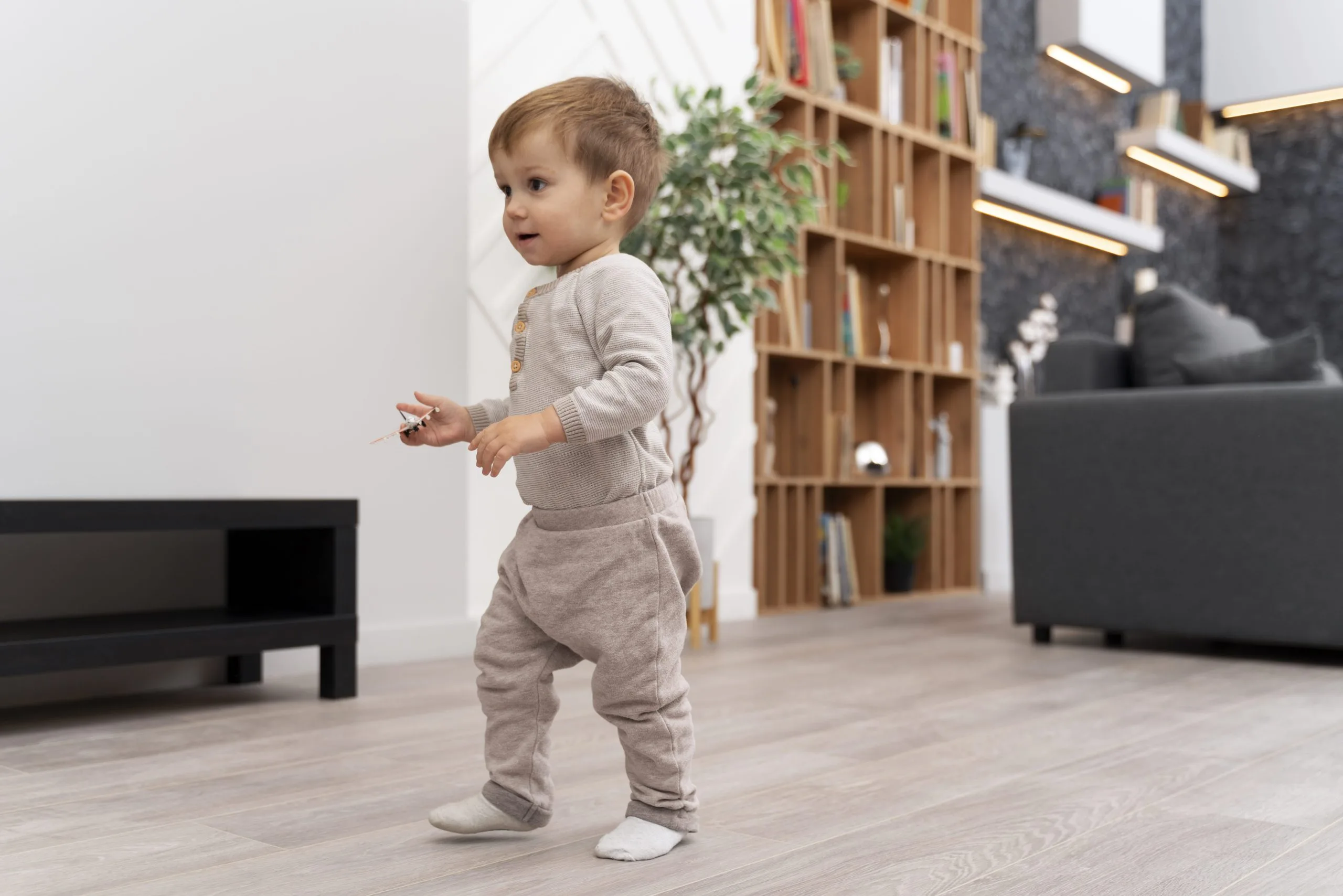 A toddler taking their first steps indoors.

