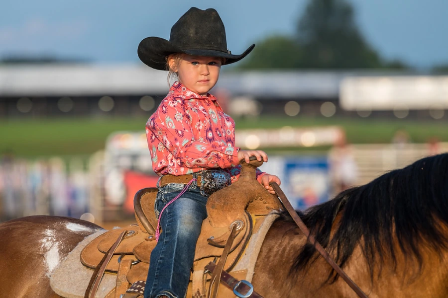 Little girl Gracie is riding a horse