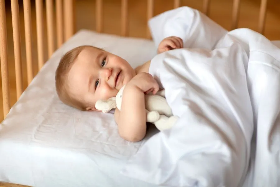 Wake a sleeping child up reasonably to protect his internal clock.