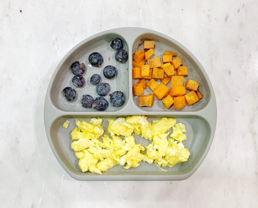 Scrambled eggs, sauteed sweet potatoes and some blueberries