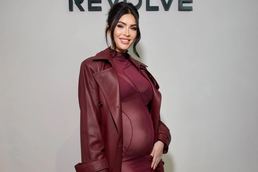 Megan Fox debuts her baby bump in red look at Revolve's Holiday Shop in Los Angeles.