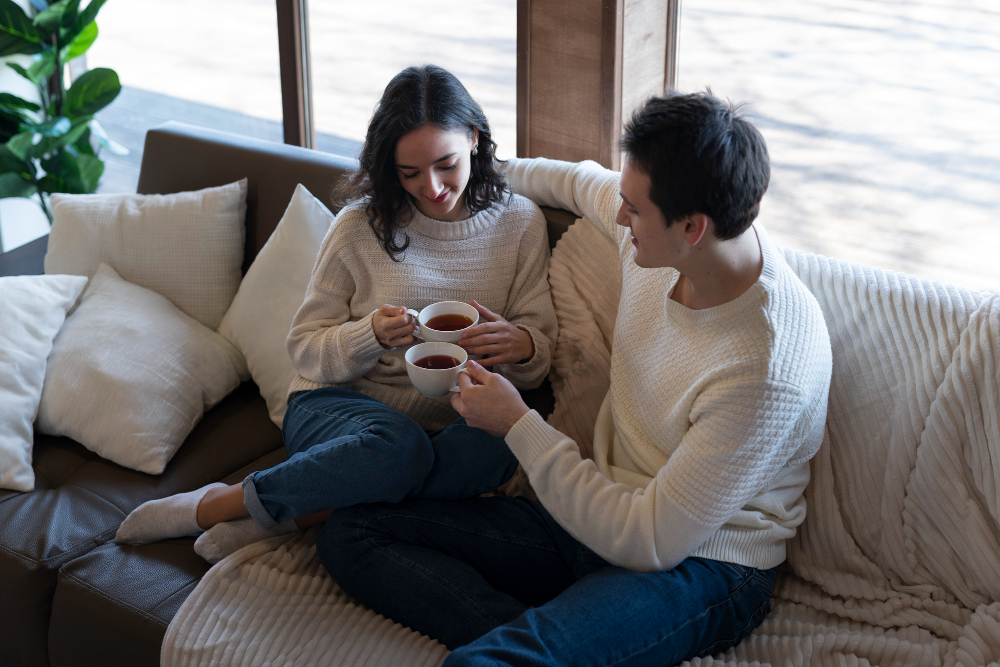 Warm, relaxed image of a couple at home together — comfortable, connected — conveying ease and partnership through the TTC journey
