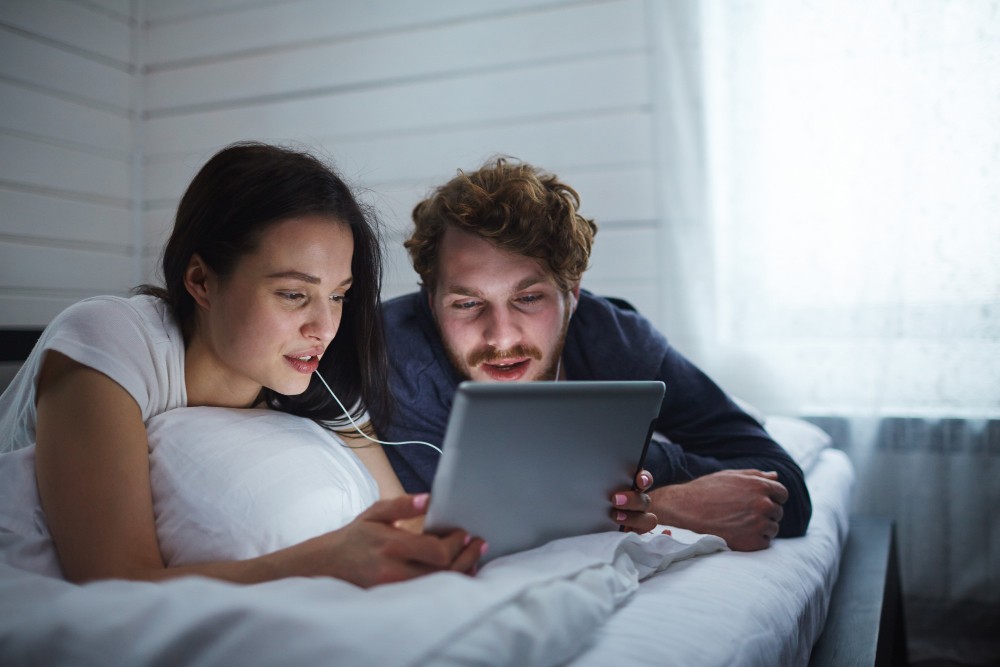 a couple at home, calm and connected, looking toward something, not at a screen or medical setting